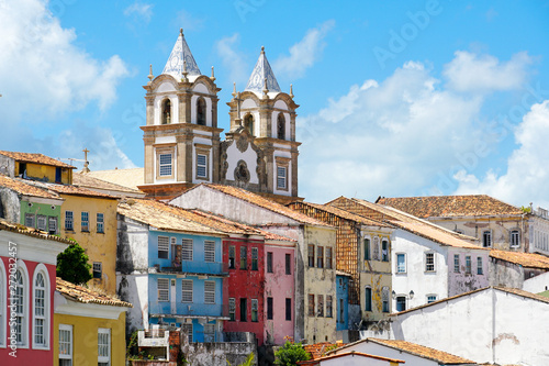 Colorful historic district of Pelourinho with cathedral on the background. The historic center of Salvador, Bahia, Brazil. Historic neighborhood famous attraction for tourist sightseeing.  photo