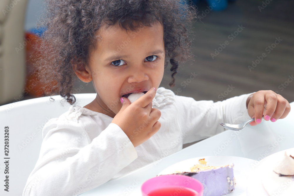 little black smile girl eating a cake. little black smile girl eating a cake.