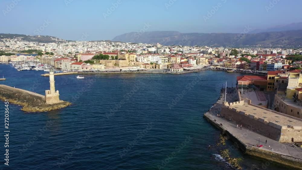 Aerial drone panoramic view video of iconic and picturesque Venetian old port of Chania with famous landmark lighthouse and traditional character, Crete island, Greece Aerial drone panoramic view video of iconic and picturesque Venetian old port of Chania with famous landmark lighthouse and traditional character, Crete island, Greece
