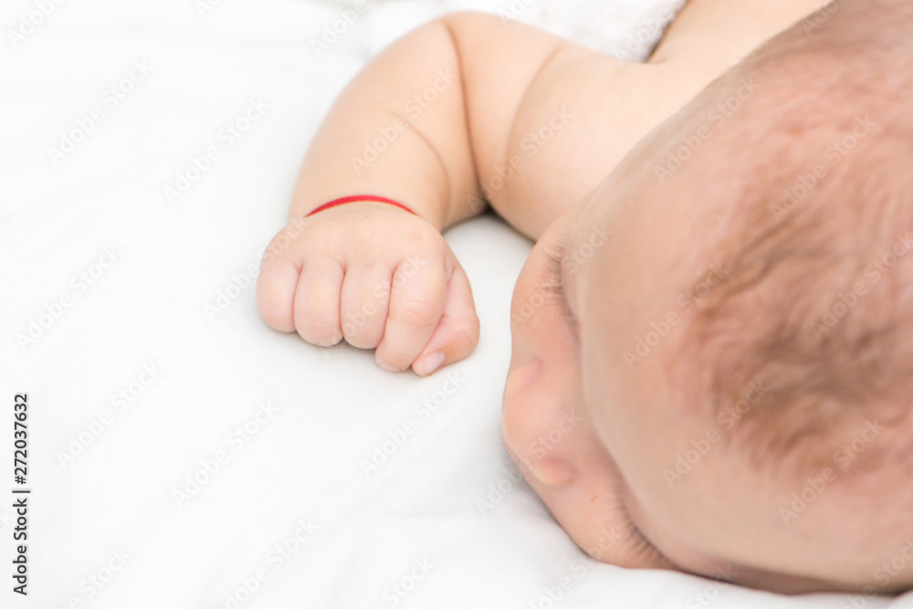 picture of a newborn baby curled up sleeping on a blanket picture of a newborn baby curled up sleeping on a blanket