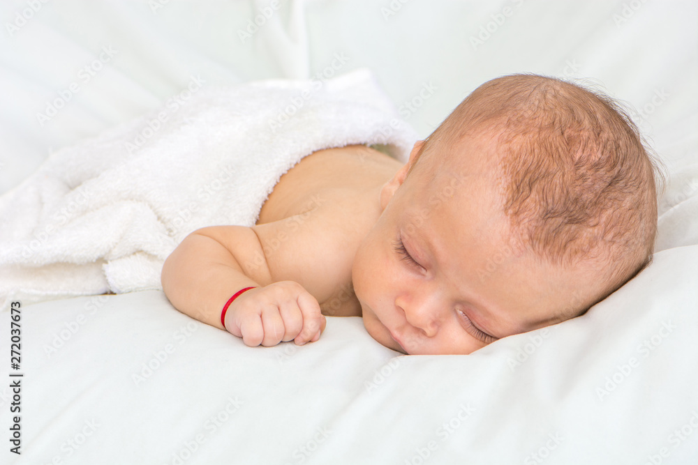 picture of a newborn baby curled up sleeping on a blanket picture of a newborn baby curled up sleeping on a blanket