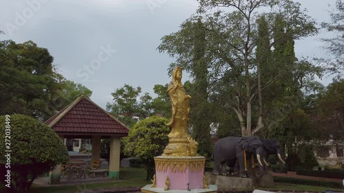 Wallpaper Mural Stunning panning shot of a large religious statue in the outdoor area of a Buddhist temple. Torontodigital.ca