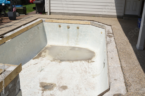 Empty swimming pool under remodel with wooden forms for new tile and coping and concrete