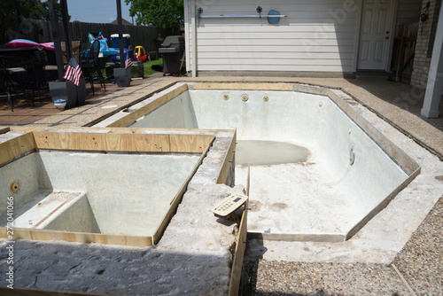 Empty swimming pool under remodel with wooden forms for new tile and coping and concrete