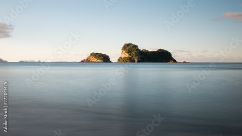 Long exposure photo of small islands at sunset off the coast of the Cathedral Cove on the Coromandel Peninsula, New Zealand
