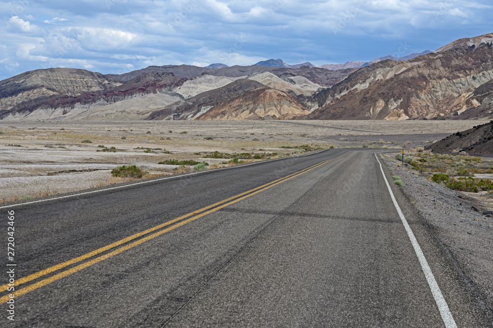 Death Valley, California / USA - May 25, 2019: Landscape in Death Valley on Artist Drive with beautiful colors, clouds moving on day time. Death Valley, California / USA - May 25, 2019: Landscape in Death Valley on Artist Drive with beautiful colors, clouds moving on day time.