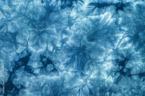 Tie dye pattern with abstract blue background. Detail of cotton fabric texture.