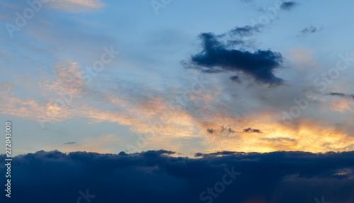 Beautiful sunset. Colorful dramatic sky at sunset. Layered-rain and Cirrus Cumulus clouds. Blue blue background with setting sun. The texture of the sunset. © Елена Труфанова