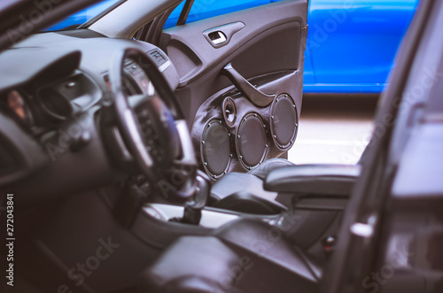 Car Audio System Speakers in the Open Door. Blurred Car Leather Interior.