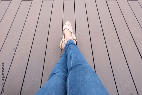 Womans legs on wood background relaxing