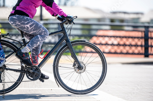 Slender woman cyclist in leggings prefers an active lifestyle and cycling through the city