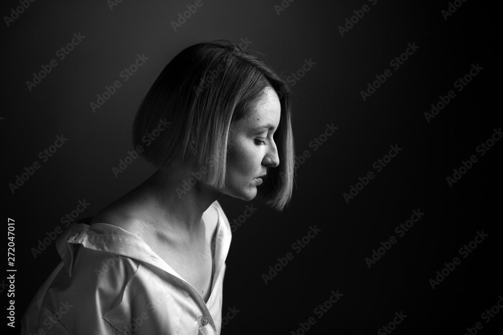 Dramatic black and white portrait of a beautiful woman on a dark background Dramatic black and white portrait of a beautiful woman on a dark background