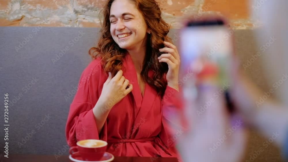 Mobile photoshoot. Pretty young woman posing in cafe. Flirty behavior. Mobile photoshoot. Pretty young woman posing in cafe. Flirty behavior.