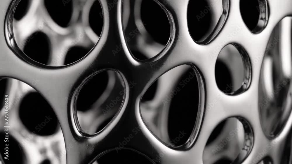 Smooth circular motion of a chrome surface, black background, abstraction Smooth circular motion of a chrome surface, black background, abstraction