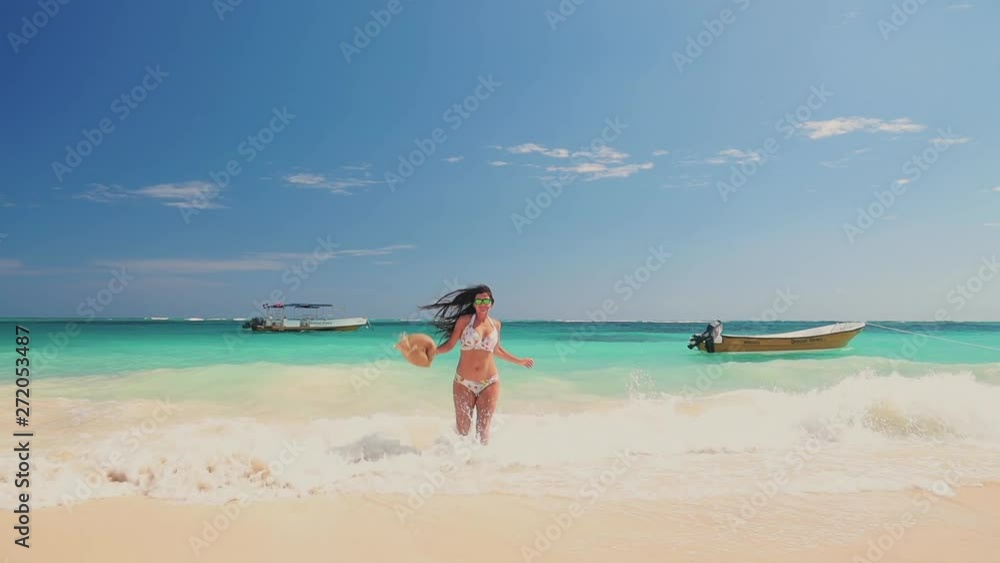 Happy sexy woman in swimsuit on tropical vacation on the island in caribbean sea with tropical beach shore Dominican Republic Happy sexy woman in swimsuit on tropical vacation on the island in caribbean sea with tropical beach shore Dominican Republic