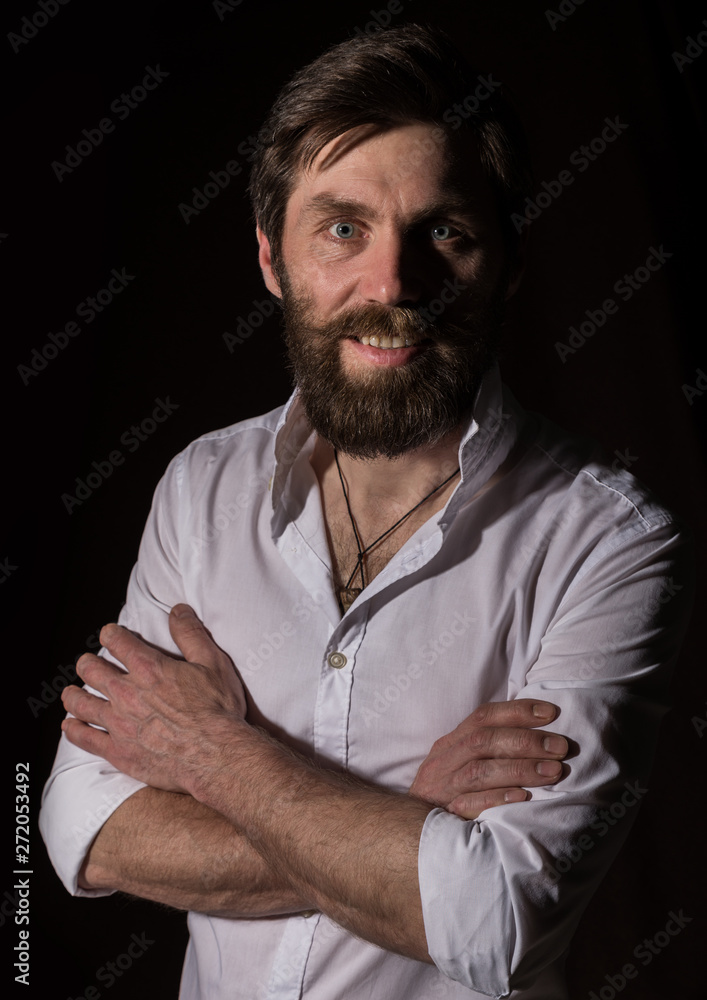 Obraz premium Portrait handsome bearded man, sexy guy on a dark background
