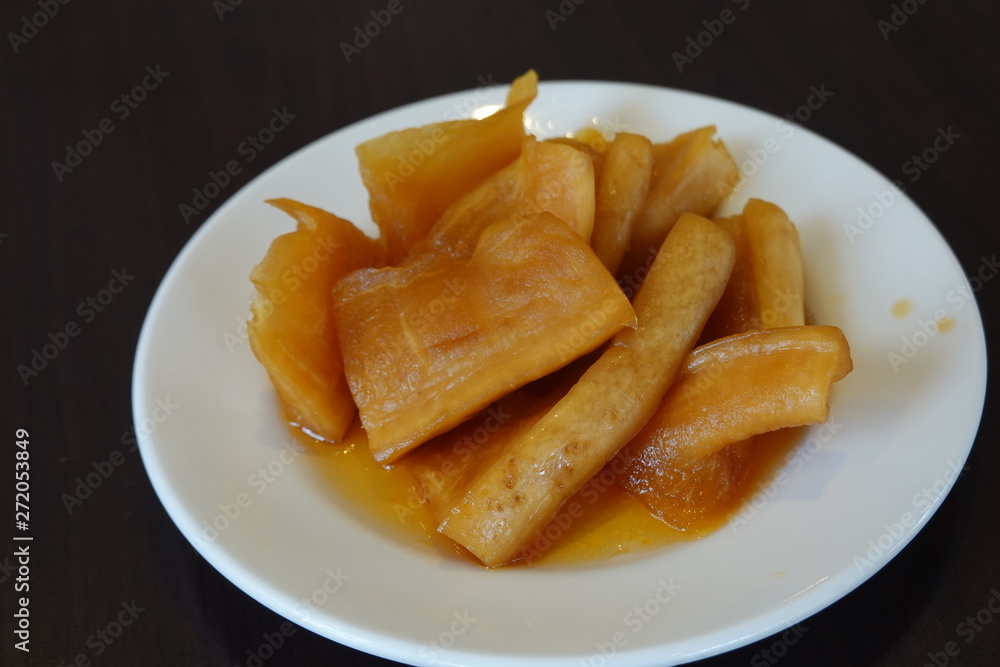 High angle view of a plate of pickled radish on table. A common side dish in Taiwanese restaurants. Traditional Taiwan food concept. High angle view of a plate of pickled radish on table. A common side dish in Taiwanese restaurants. Traditional Taiwan food concept.