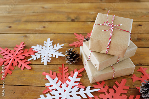 Christmas presents laid on a wooden table background © Anastasiia