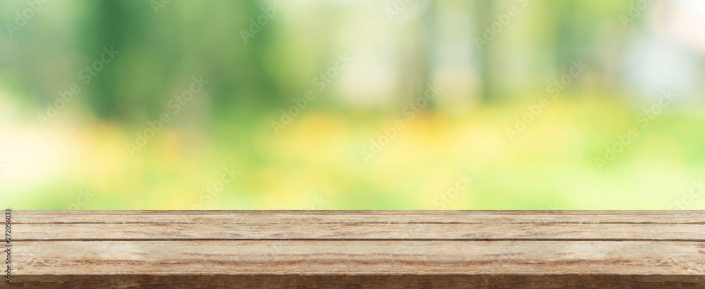 wood table top in front of natural blur bokeh background and copy space. display or montage products banner size. wood table top in front of natural blur bokeh background and copy space. display or montage products banner size.