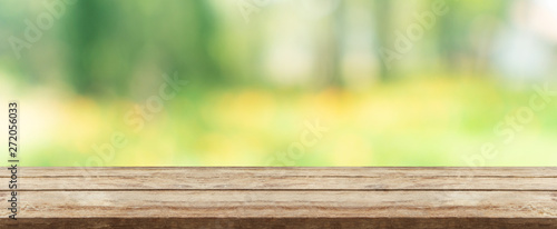 wood table top in front of natural blur bokeh background and copy space. display or montage products banner size.