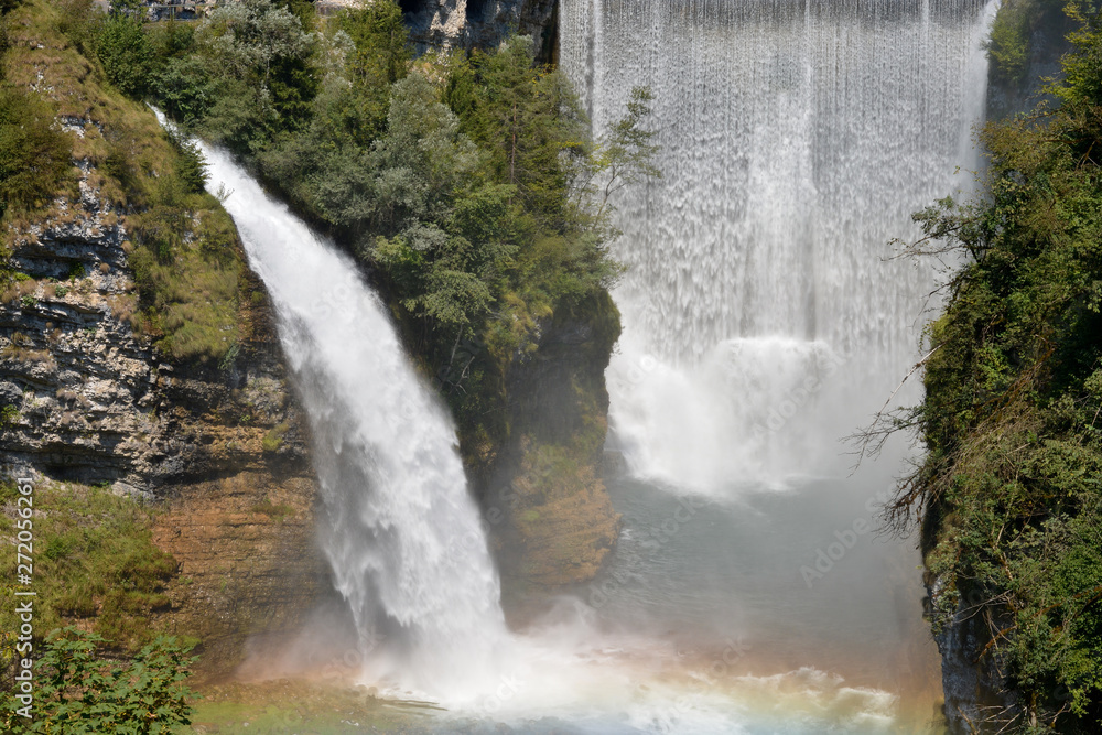 Fototapeta premium Two large waterfalls form a rainbow