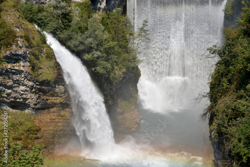 Two large waterfalls form a rainbow