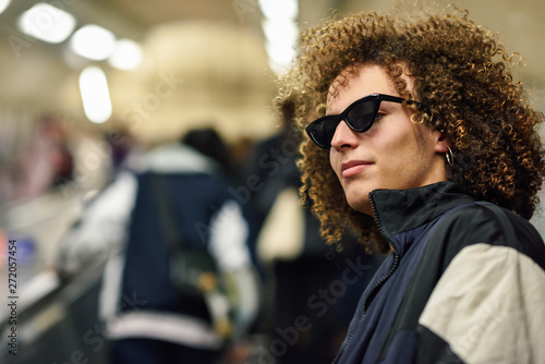 Young man going upstairs at a subway station.