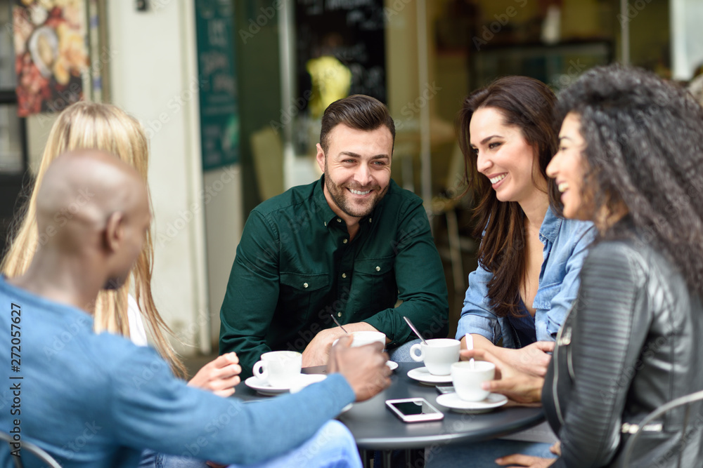 Multiracial group of five friends having a coffee together Multiracial group of five friends having a coffee together
