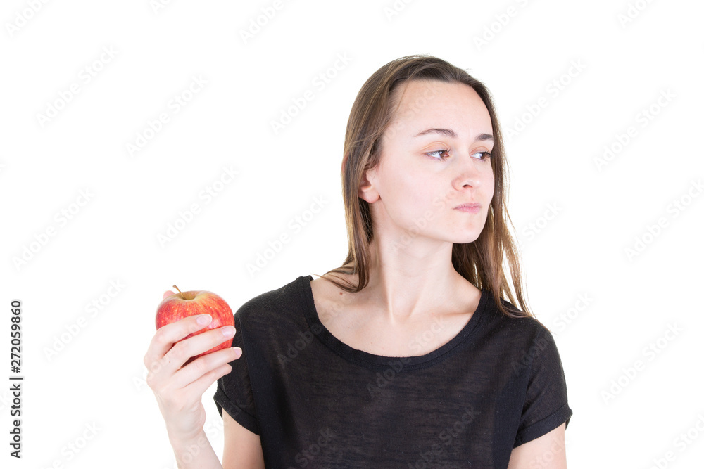 disgusted young woman holding red apple and looking aside in start vegetarian healthy diet disgusted young woman holding red apple and looking aside in start vegetarian healthy diet