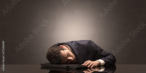 Young businessman fell asleep at his workplace with copy space