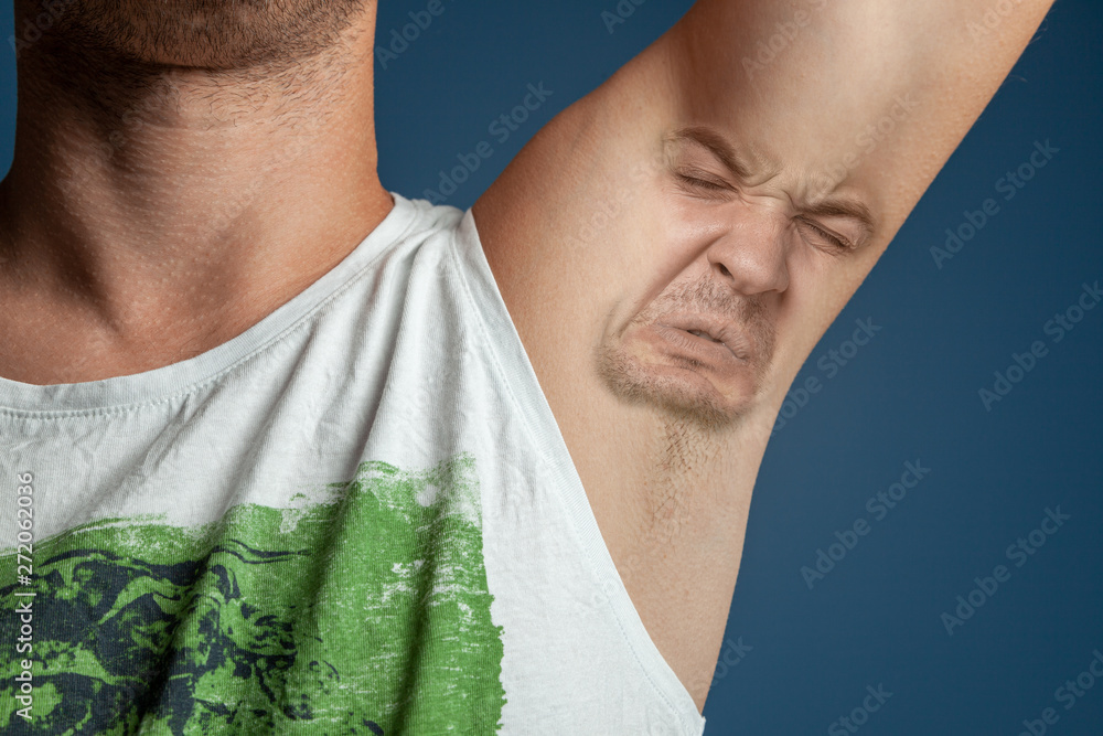 Smelly armpits in men. Concept of twisted panting face from bad smell.  Stock Photo | Adobe Stock