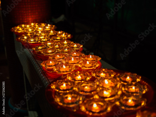 SINGAPORE, 18 MAY 2019 -A row of Buddhist oil lamps in a temple at Vesak Day celebrations. giving off a calm, serene, spritual warm light