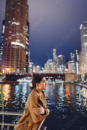 beautiful young woman walking near Chicago river at night © prostooleh