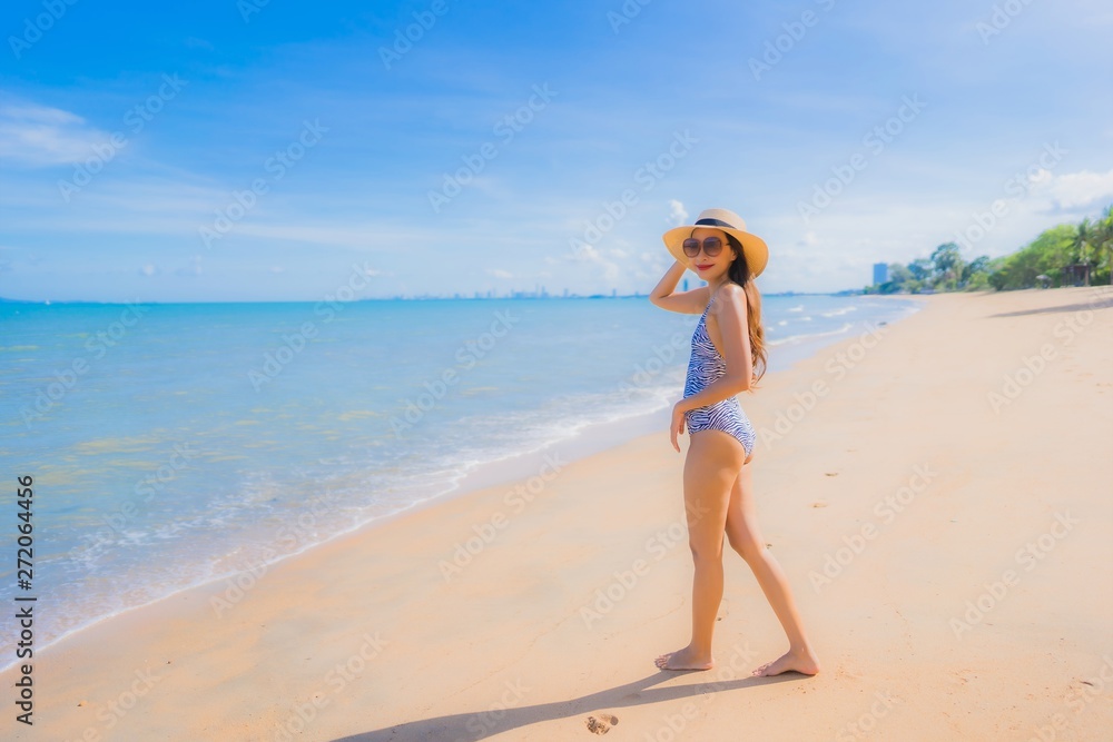 Portrait beautiful young asian woman happy smile relax on the tropical beach sea ocean for leisure travel Portrait beautiful young asian woman happy smile relax on the tropical beach sea ocean for leisure travel