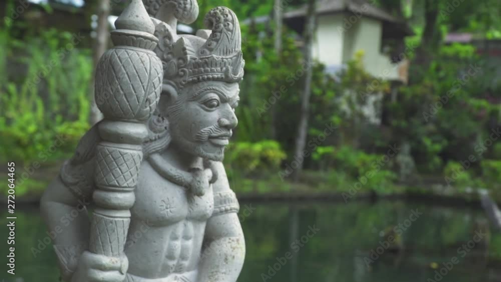 Indonesia god statue in front Bali temple, Indonesia. Traditional indonesian hindu symbol. Ancient sculpture religious idol. Balinese spiritual architecture. Asian culture. Tourism and travel concept. Indonesia god statue in front Bali temple, Indonesia. Traditional indonesian hindu symbol. Ancient sculpture religious idol. Balinese spiritual architecture. Asian culture. Tourism and travel concept.