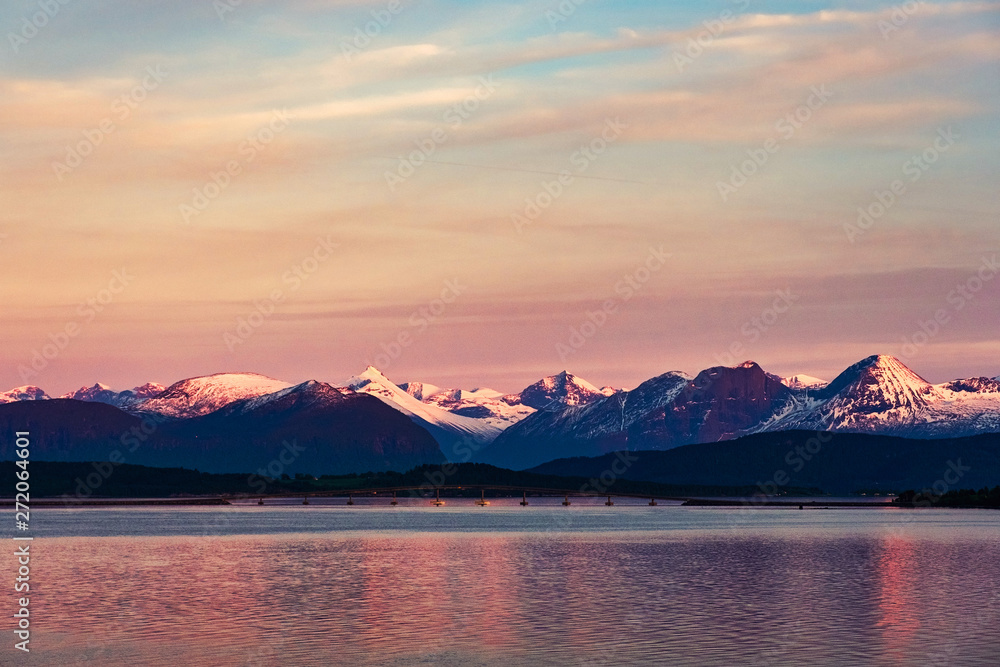 Sunset view of the mountain range in Molde, Norway during the cloudy evening