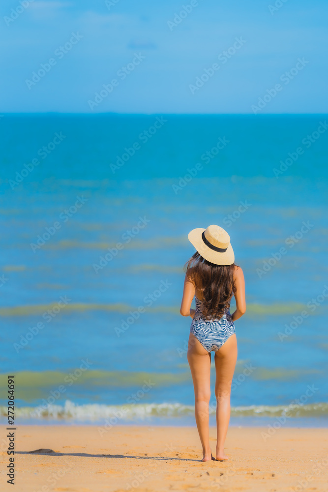 Portrait beautiful young asian woman happy smile relax on the tropical beach sea ocean for leisure travel Portrait beautiful young asian woman happy smile relax on the tropical beach sea ocean for leisure travel