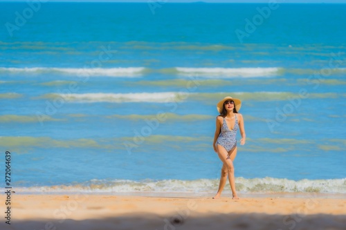 Portrait beautiful young asian woman happy smile relax on the tropical beach sea ocean for leisure travel