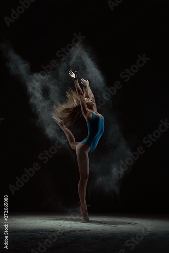 Fototapeta Naklejka Na Ścianę i Meble -  Woman throwing dust and dancing on tiptoes