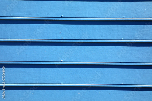 Abstract background image of blue painted wooden building exterior surface