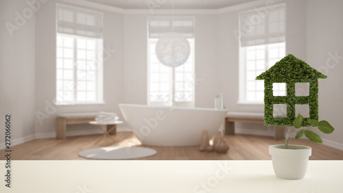 White table top or shelf with green plant in pot shaped like house, modern blurred bathroom with bathtub in the background, interior design, real estate, eco architecture concept idea © ArchiVIZ