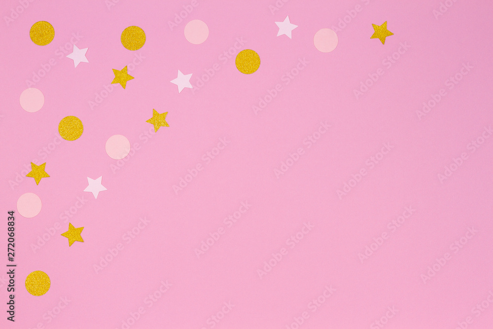 Festive pink background. Colorful confetti and golden stars on light pink background. Top view