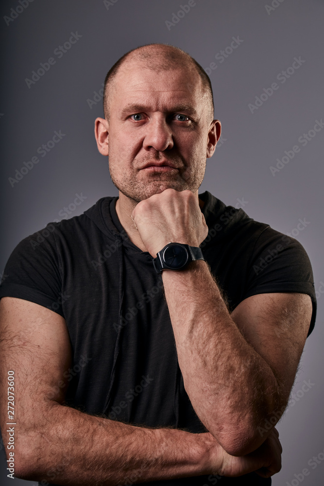 Unhappy depressed man with very sad eyes looking with hand under the face. Closeup portrait of russian actor Unhappy depressed man with very sad eyes looking with hand under the face. Closeup portrait of russian actor