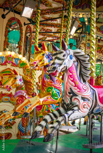 Decorated wooden animals on carousel attraction