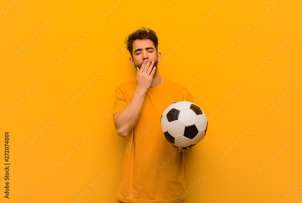 Young soccer player man tired and very sleepy Young soccer player man tired and very sleepy