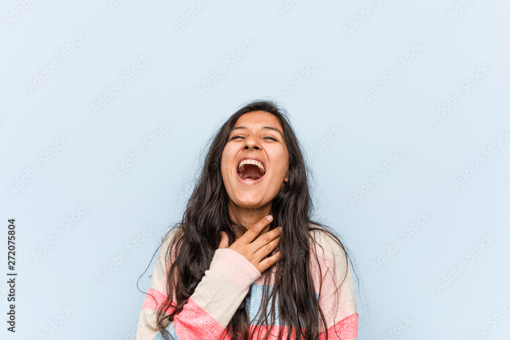Young fashion indian woman laughs out loudly keeping hand on chest. Young fashion indian woman laughs out loudly keeping hand on chest.