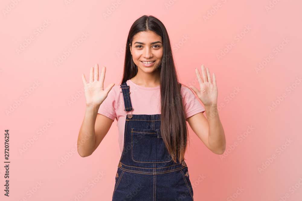 Young pretty arab woman wearing a jeans dungaree showing number ten with hands. Young pretty arab woman wearing a jeans dungaree showing number ten with hands.