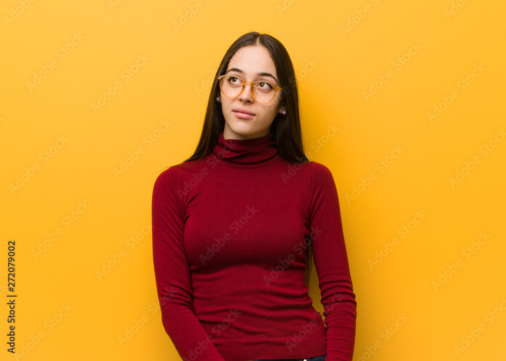 Fototapeta premium Intellectual young girl dreaming of achieving goals and purposes