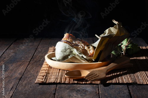 hot and fresh rice dumpling steam chinese food on vintage table photo