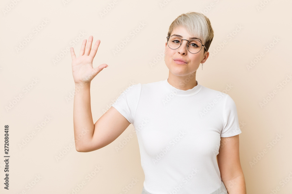 Young authentic natural woman wearing a white shirt smiling cheerful showing number five with fingers. Young authentic natural woman wearing a white shirt smiling cheerful showing number five with fingers.